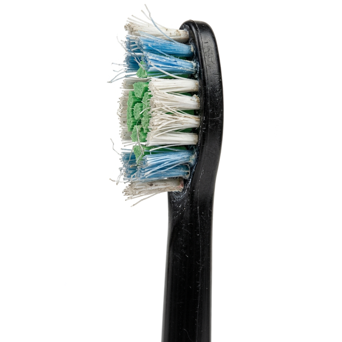 Worn electric toothbrush head with frayed blue, white, and green nylon bristles on a black handle.